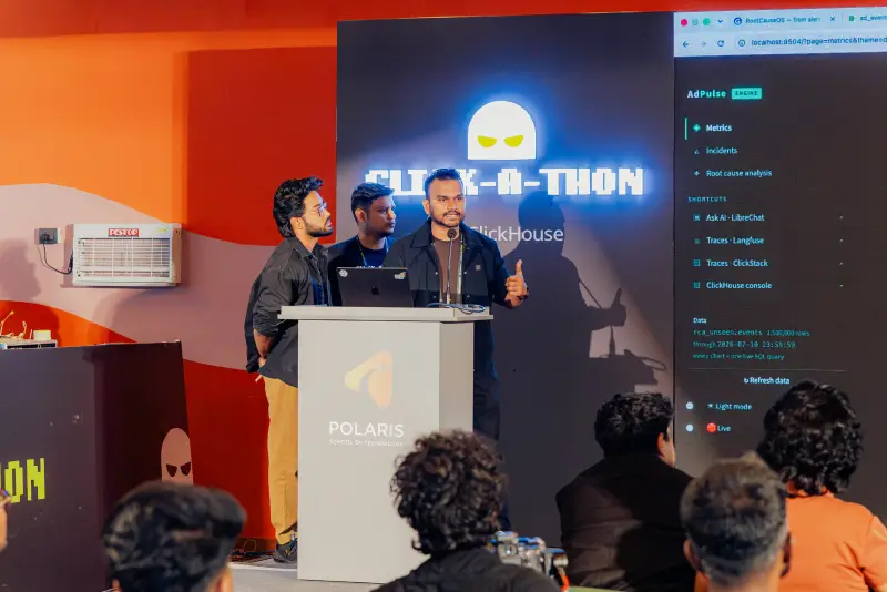 Deepak presenting RootCauseOS at the Click-a-thon podium with its dashboard on screen