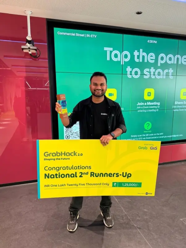 Deepak holding the GrabHack 2.0 National 2nd Runners-Up cheque